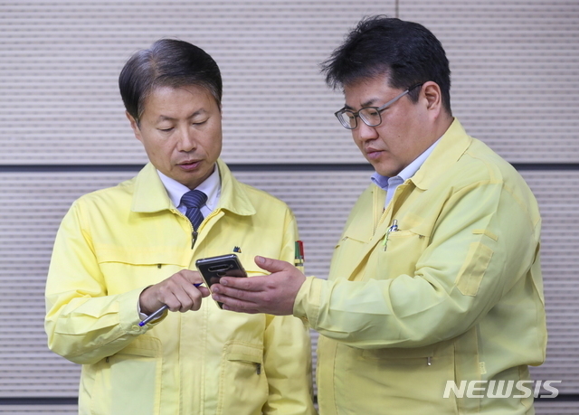 김강립(왼쪽) 중앙재난안전대책본부 1총괄조정관이 지난 4월1일 오전 11시 정부세종청사에서 열린 신종 코로나 바이러스 감염증(코로나19) 정례브리핑에 앞서 손영래(오른쪽) 중앙사고수습본부 전략기획반장과 휴대전화를 보고 있다.(사진=뉴시스)