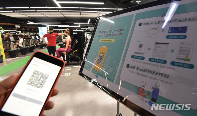 개인신상정보가 담긴 QR 코드를 활용한 전자출입명부 시스템이 본격적으로 시행된 10일 오후 경기 수원시 영통구 원천동 한 헬스클럽 출입구에서 관계자가 QR코드를 찍고 있다.(사진=뉴시스)