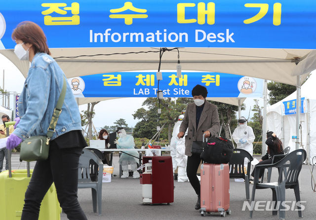 제주국제공항 내에 마련된 워킹 스루 진료소(개방형 선별진료소)에서 국외 입국자를 대상으로 코로나19 검사가 진행되고 있다. (사진=뉴시스)