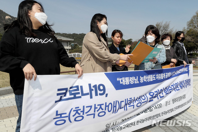 나사렛대학교 농 학생들이 지난4월 6일 오후 서울 종로구 청와대 분수대 앞에서 장애의 벽을 허무는 사람들 등 시민단체 주최로 열린 '신종 코로나바이러스 감염증(코로나19) 관련 농(청각장애) 대학생의 온라인 학습지원 확대 정책제안' 기자회견에 참석해 수어로 발언하고 있다.(사진=뉴시스)
