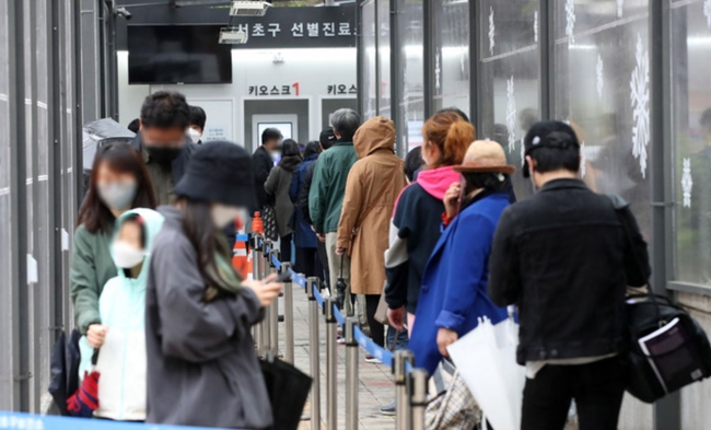 코로나19 신규 확진자가 587명으로 집계된 지난 12일 오후 서울 서초구 서초보건소에 마련된 코로나19 선별진료소에서 시민들이 검사를 받기 위해 줄 서 있다 (사진=뉴시스 제공)