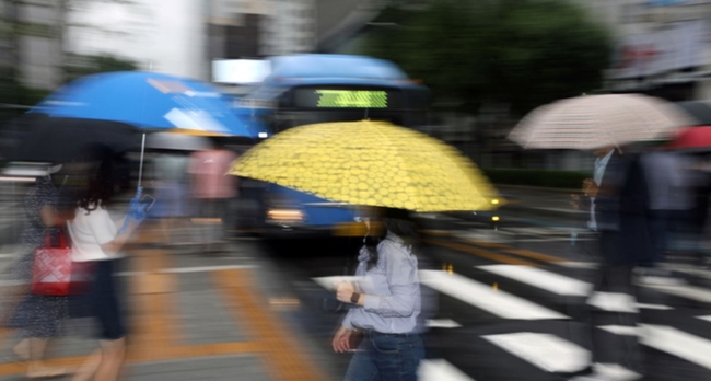 비가 내리는 서울 종로구 광화문광장에서 시민들이 우산을 쓰고 출근하고 있다 (사진=뉴시스 제공)