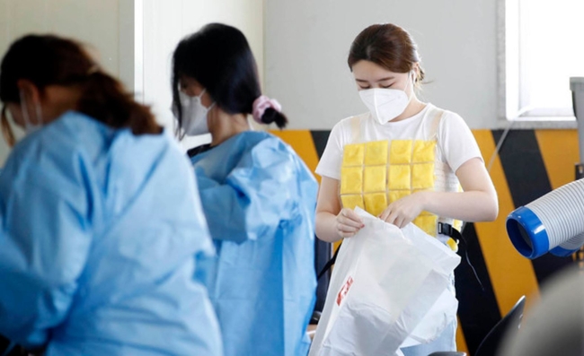 절기 상 하지인 지난 21일 광주 북구 용봉동 선별진료소에서 의료진이 무더위를 이겨내고자 '얼음 조끼'를 착용하고 있다 (사진=광주 북구 제공)