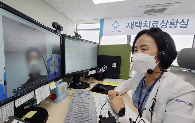 지난 19일 경기도 성남시의료원 재택치료 상황실에서 관계자가 '팍스로비드'를 복용하며 재택치료를 하고 있는 환자의 증세 등을 화상전화를 이용해 체크하고 있다.