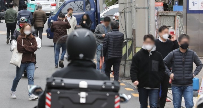 새로운 사회적 거리두기 조정 방안이 발표된 18일 오후 서울 시내 식당가에서 시민들이 식사를 위해 이동하고 있다. 오는 21일부터 다음 달 3일까지 코로나19 백신 접종 여부와 관계없이 전국 어디서나 8명까지 모임이 가능하다. 다중이용시설 이용 시간은 종전처럼 오후 11시까지다.
