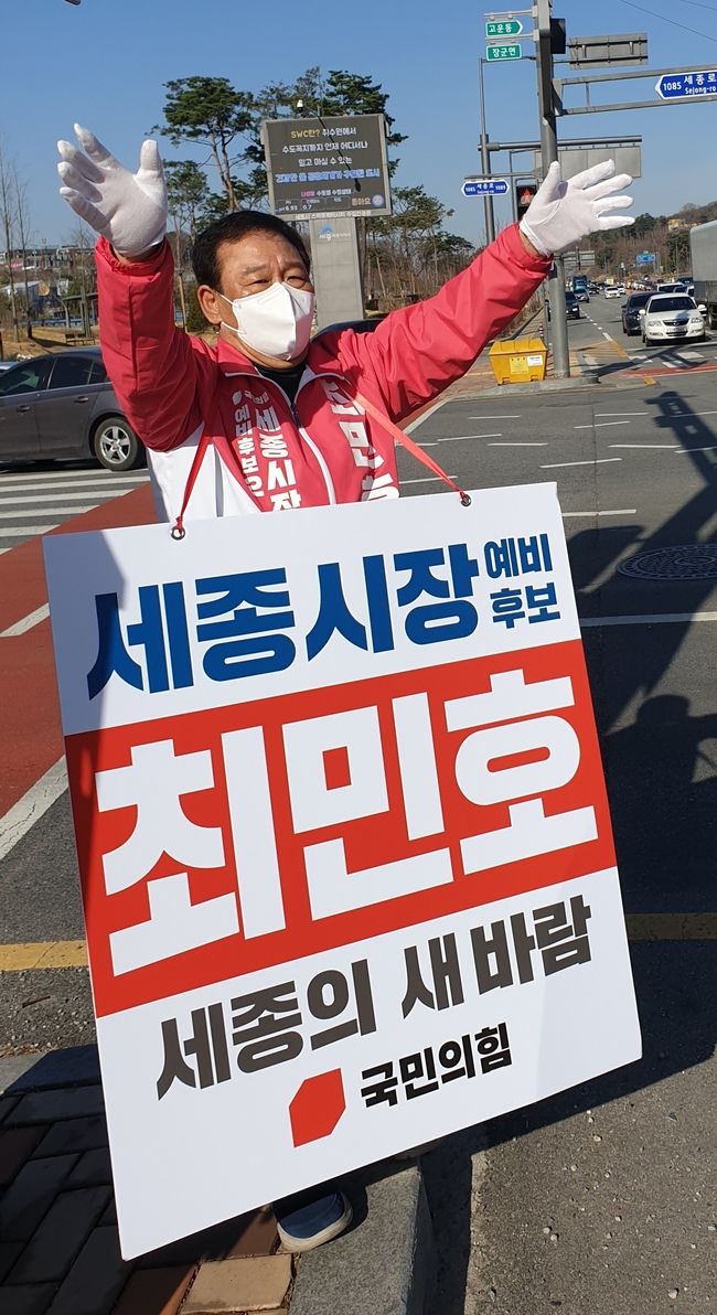 최민호 국민의힘 세종시장 예비후보가 지난 4월 1일 종촌동 너비뜰 교차로에서 출근길 시민을 대상으로 인사를 하고 있다. 이날 운전자들은 손짓 또는 라이트, 클랙슨 등으로 최 예비후보를 지지하는 등 응원을 표시했다