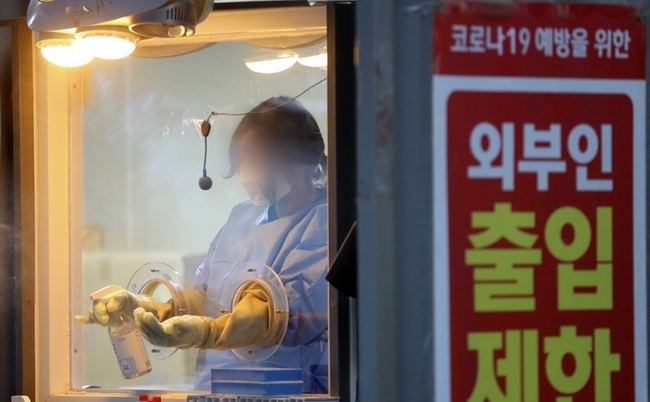 코로나19 신규 확진자수가 사흘째 전주 대비 줄며 감소세를 보이고 있는 지난 30일 서울 용산구보건소에서 관계자가 코로나19 검사를 마친 뒤 소독을 하고 있다. 이날 신규 확진자 수는 6만5207명으로 집계됐다. (사진=뉴시스)