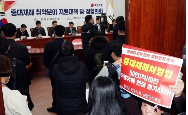 유의동 국민의힘 정책위의장이 지난해 12월27일 오전 서울 여의도 국회에서 열린 중대재해 취약분야 지원대책 관련 당정협의회에서 발언을 하고 있다. 입구에서 강은미 정의당 의원과 고(故) 김용균씨의 어머니 김미숙 김용균재단 이사장 등이 50인(건설업은 공사금액 50억) 미만 적용유예 연장 폐기 피켓시위를 하고 있다. (사진=뉴시스 제공)