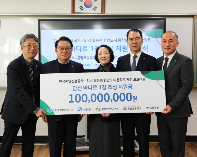 Sh수협은행이 한국해양진흥공사(사장 안병길)와 손잡고 ‘부산 항만도시 어린이 통학로 개선사업’을 지원한다. 사진은 지난 16일, 부산광역시 용당초등학교에서 진행된 지원 기금 전달식에서 참석자들이 기념촬영을 하는 모습. (왼쪽부터) 부산광역시교육청 학교안전총괄과 김덕명 사무관, 한국해양진흥공사 안병길 사장, 용당초등학교 김정숙 교장, 수협은행 신학기 은행장, 초록우산 김희석 부산지역본부장.(사진=Sh수협은행 제공)